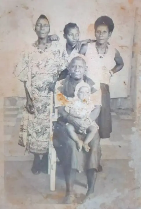 A baby sitting on her great-grandmother’s lap, surrounded by her grandmother, mother, and great-aunt — four generations of strong Zambian women