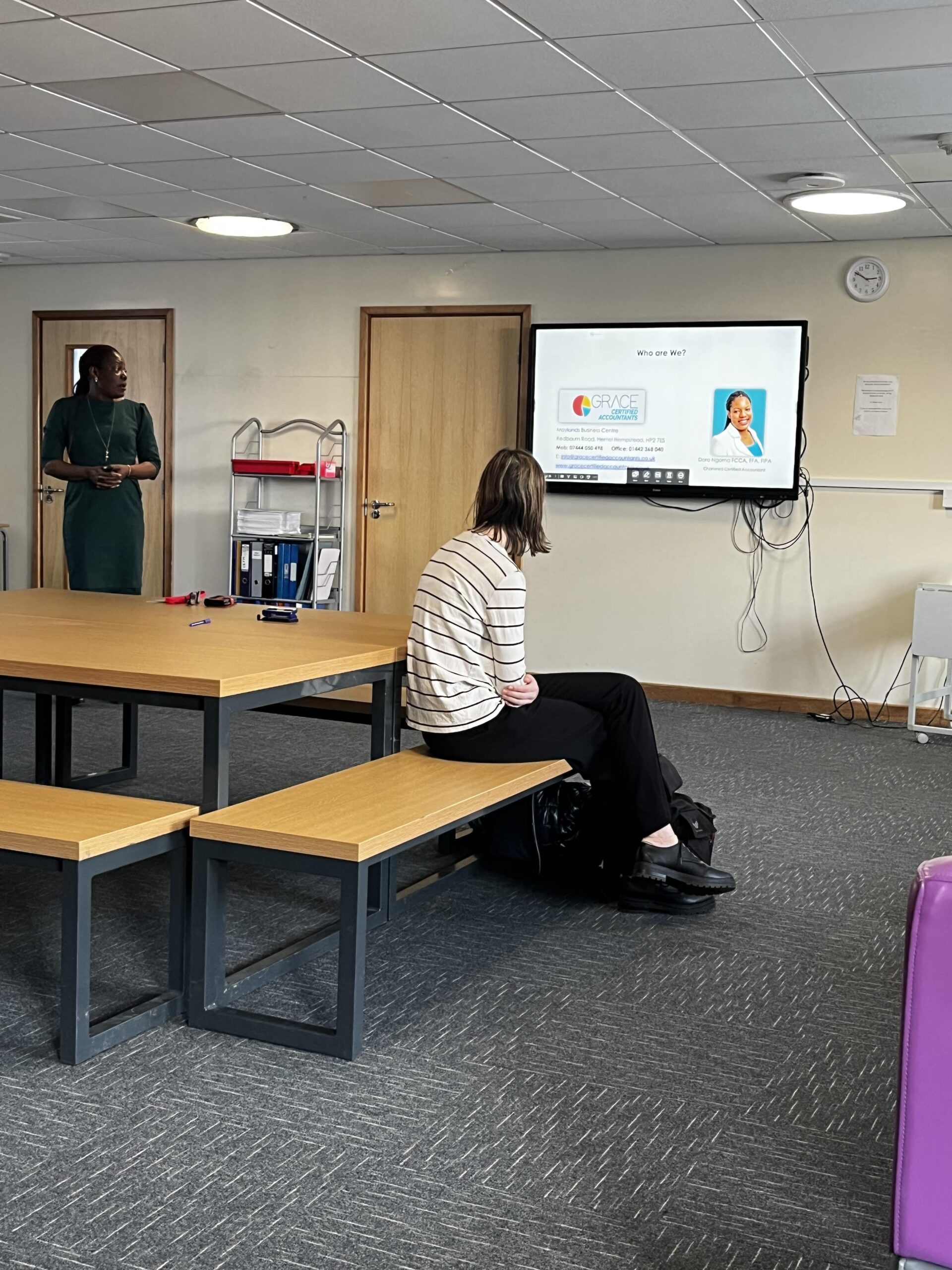 A careers day speaker presenting to students at Adeyfield Academy, with a Grace Certified Accountants slide on screen